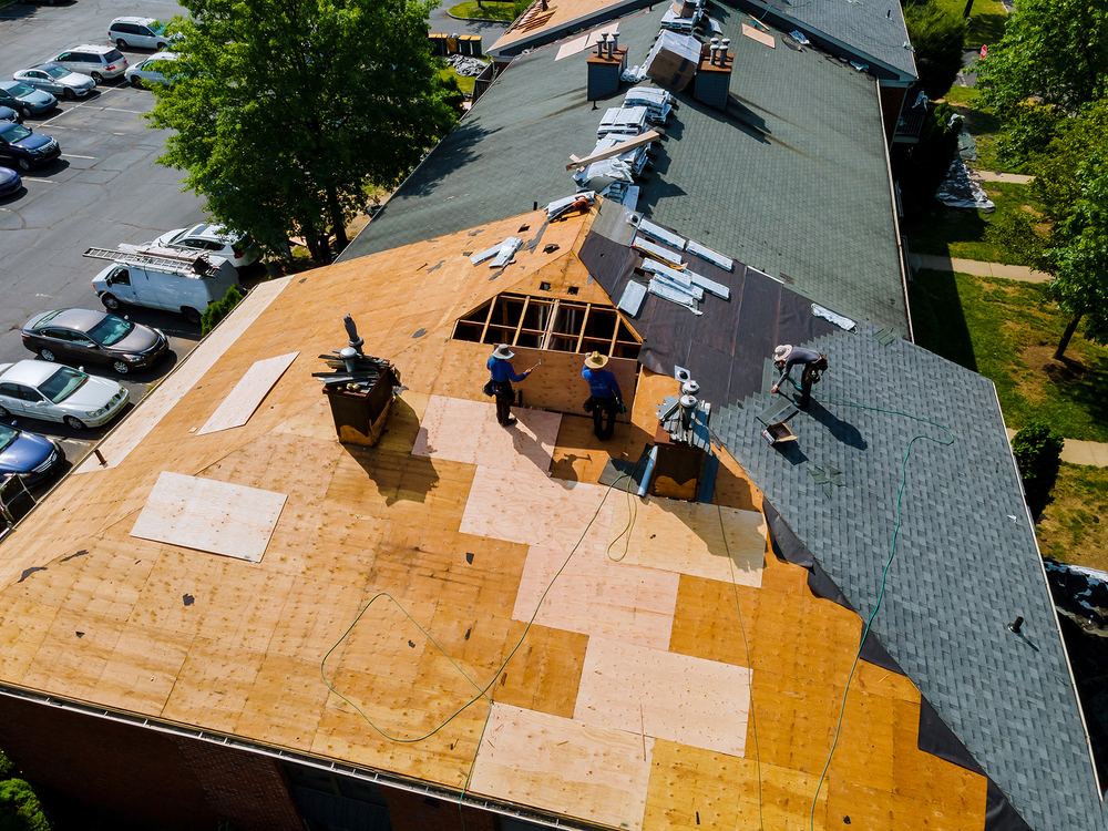 Aerial view of a roof tear-off with fresh decking going down