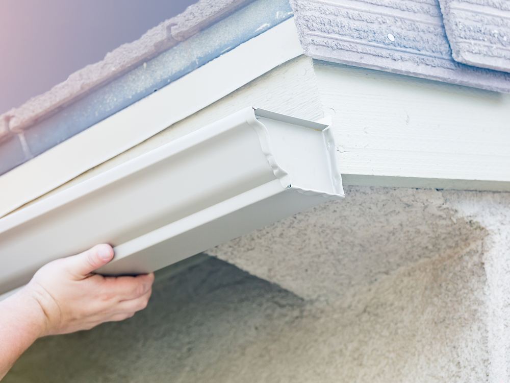 New seamless gutter being fitted along the fascia