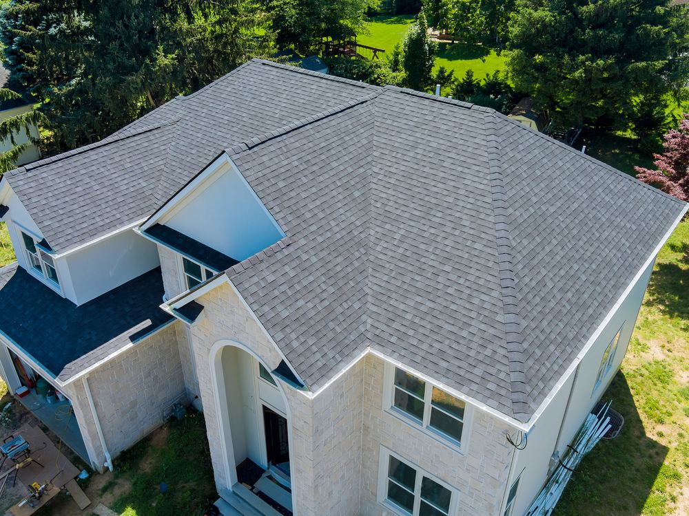 Aerial view of a completed roof replacement on a large home